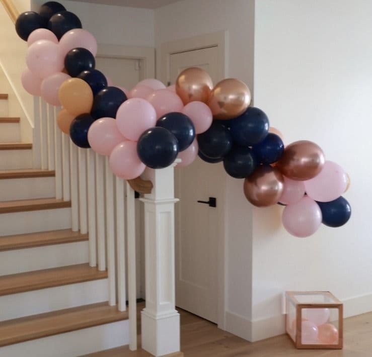 Blush, navy and rose gold balloon garland following a staircase banister