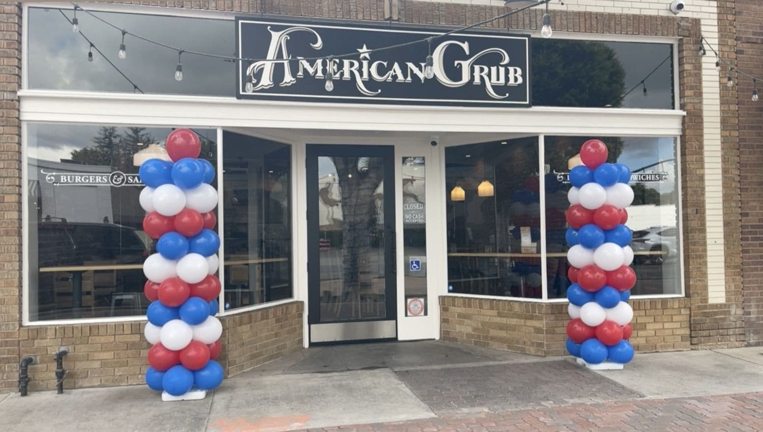 Red, white and blue balloon columns flanking a restaurant entrance